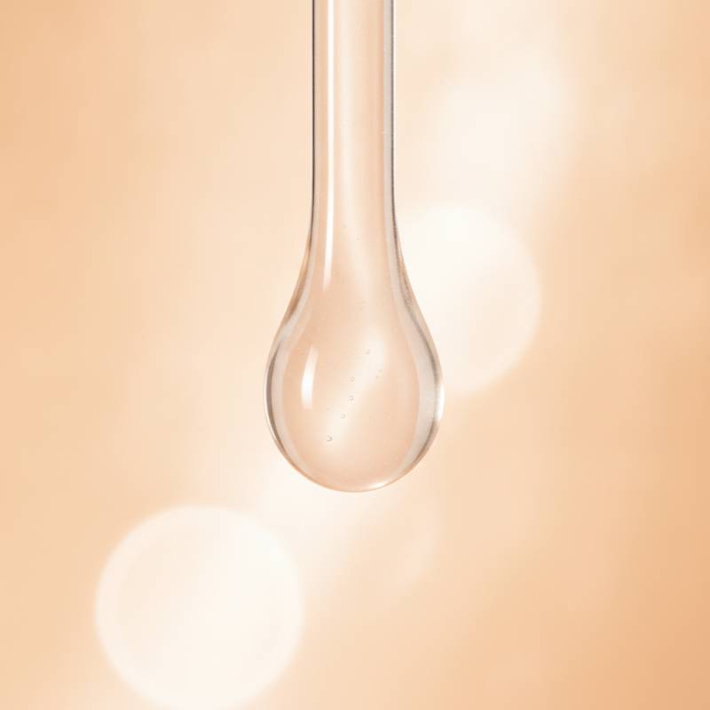 A close-up of clean, clear skin with a lightweight cream texture being applied, representing non-comedogenic makeup.