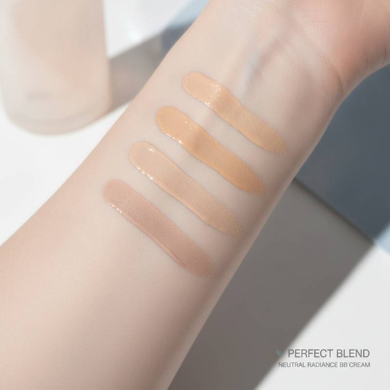 Swatches of very fair, cool-toned and warm-toned BB creams on pale skin, showing a seamless blend.